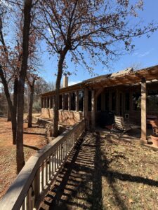 exterior cleaning and maintenance of a home with visible trees and a patio area