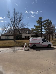 pane fully clean service vehicle parked outside a residential home with grass and trees in the yard