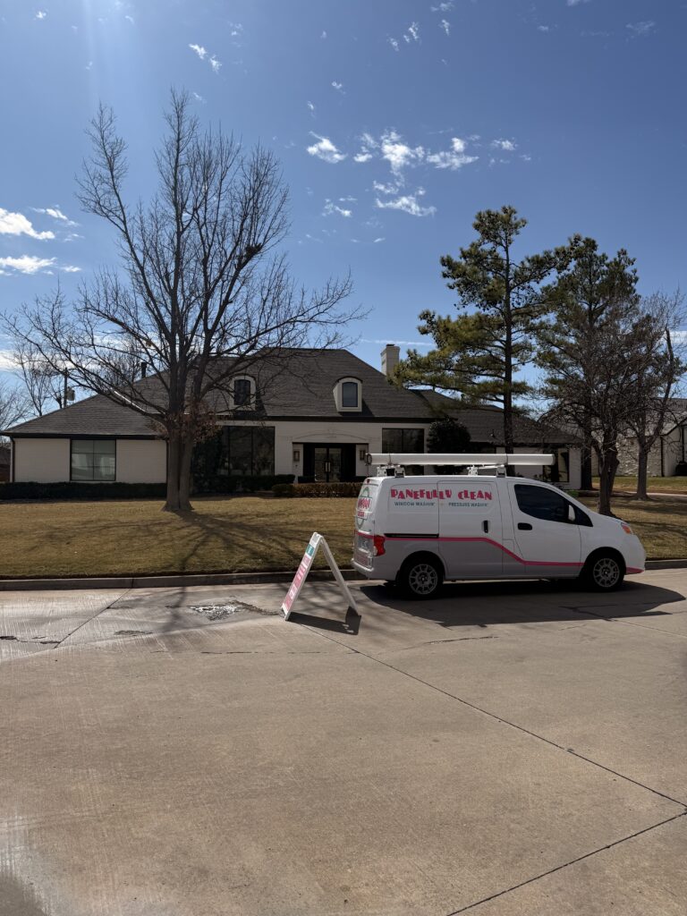 pane fully clean service vehicle parked outside a residential home with grass and trees in the yard