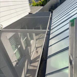 south tampa gutter and window cleaning cleaning a glass roof panel alongside a roof using ladders and safety measures