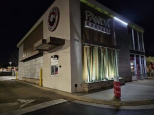 panda express restaurant exterior at night featuring a drive-thru window and decorative lighting along the building