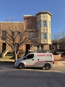 pane fully clean service vehicle parked in front of residential building likely preparing for window cleaning or pressure washing