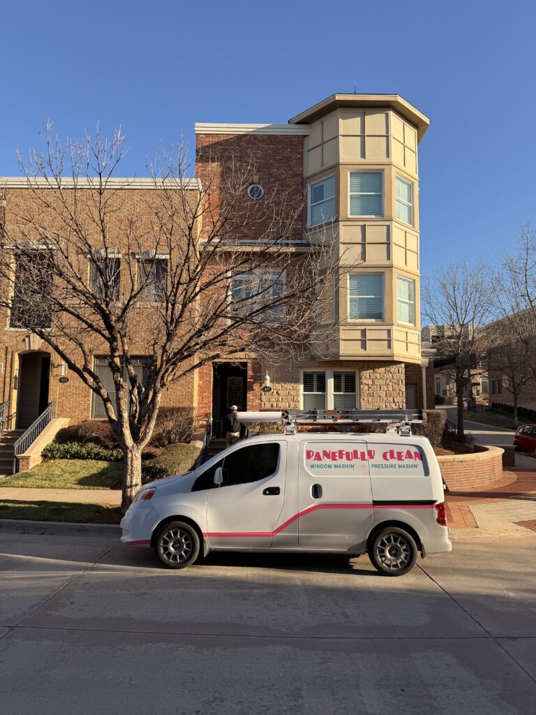 pane fully clean service vehicle parked in front of residential building likely preparing for window cleaning or pressure washing