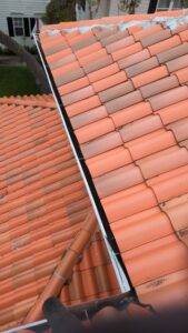 roof inspection of terracotta tiles showing potential wear and areas needing repair or cleaning with visible discoloration