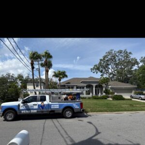 service truck parked near a residential property with lush landscaping indicating exterior cleaning services being offered in the area