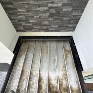 cleaning of a gutter system showing dirt and debris accumulation inside the trough area