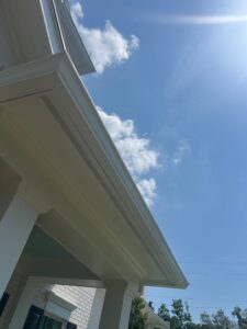 gutter cleaning service showing clear gutters and bright blue sky with minimal cloud coverage