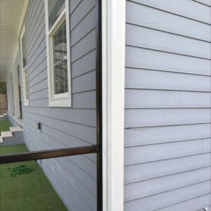 house with gray siding showing clean corners and window frames possibly preparing for gutter and window cleaning services