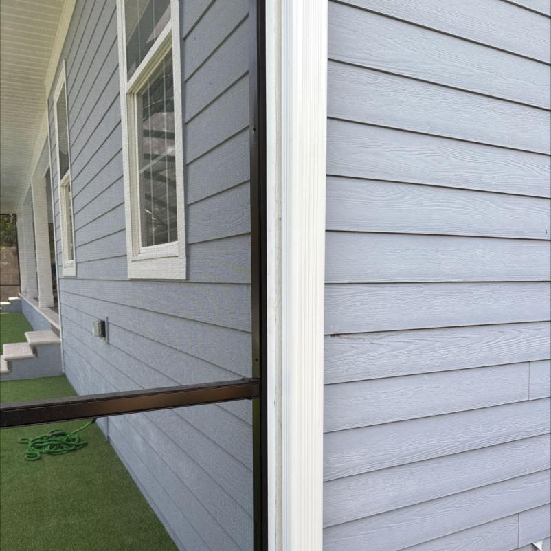 house with gray siding showing clean corners and window frames possibly preparing for gutter and window cleaning services