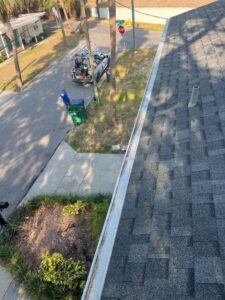 gutter cleaning service showing a well maintained rooftop with clean gutter system and nearby street view
