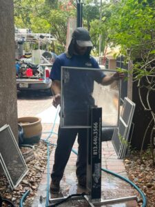 south tampa gutter and window cleaning cleaning window screens using a specialized frame and water hose technique