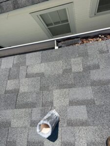 roof inspection with a view of shingles and a ventilation pipe near a gutter area