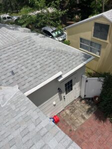 roof inspection of a residential property with gray shingles and visible landscaping around the structure