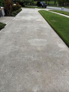 concrete sidewalk with some dirt and stains possibly being prepared for cleaning or pressure washing service