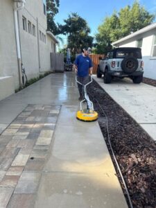 south tampa gutter and window cleaning pressure washing a concrete surface with a flat surface cleaner machine